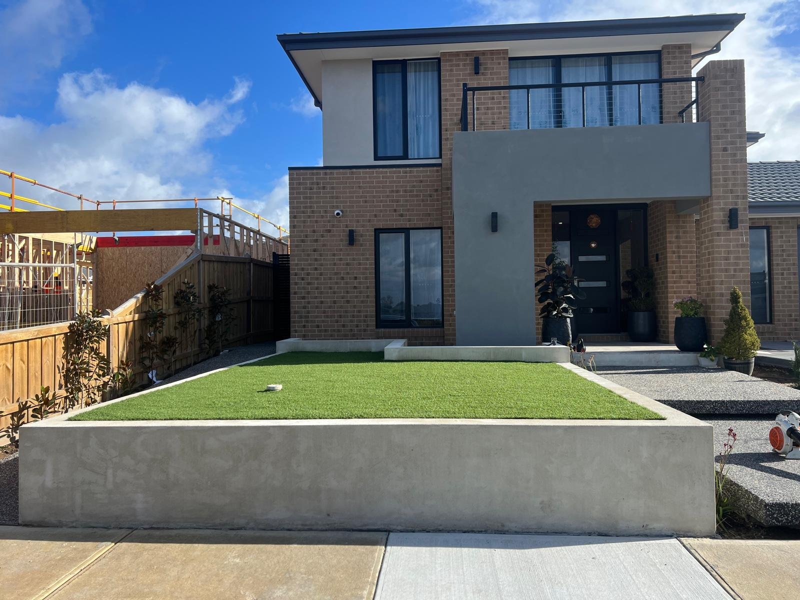 Synthetic turf installation with concrete retaining wall Melbourne